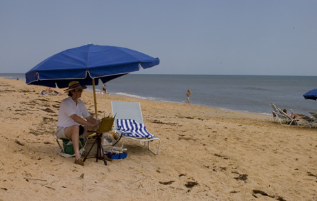Tom painting on the beach